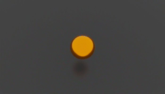 A gold ball exploding into confetti with blue blobs expanding outwards from the inside.